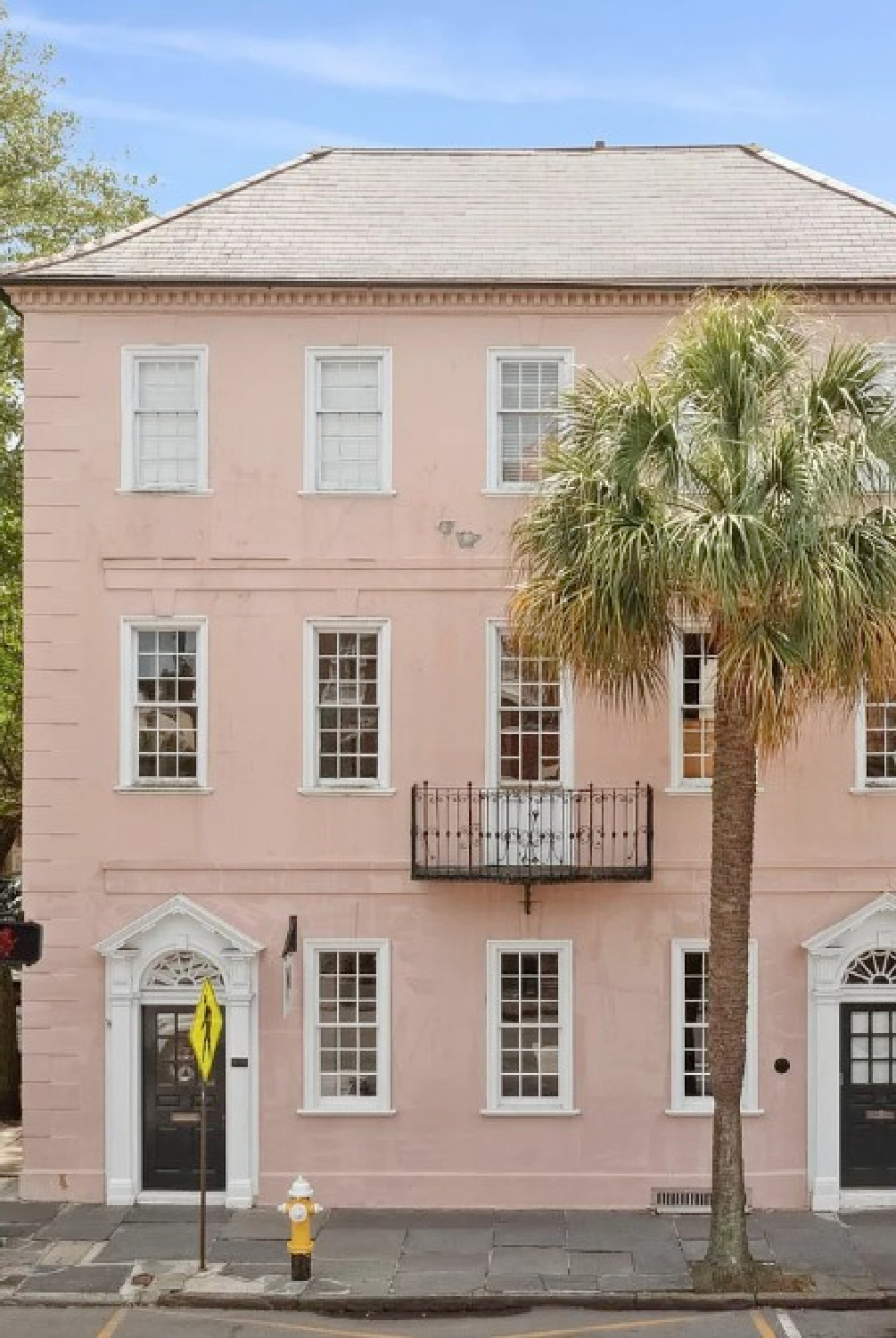 Lovely pink stucco exterior on a historic Charleston home on 49 Broad Street. #charlestonhomes #pinkhouses