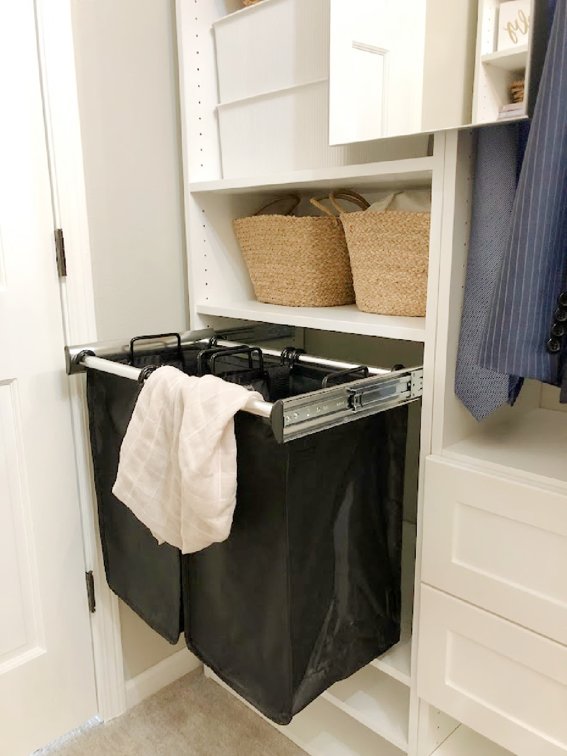 Hamper pullouts from Modular Closets in our new custom designed walk-in closet. Come see the DIY with before/after photos! #laundryhampers #customclosetfeatures #closetdiys