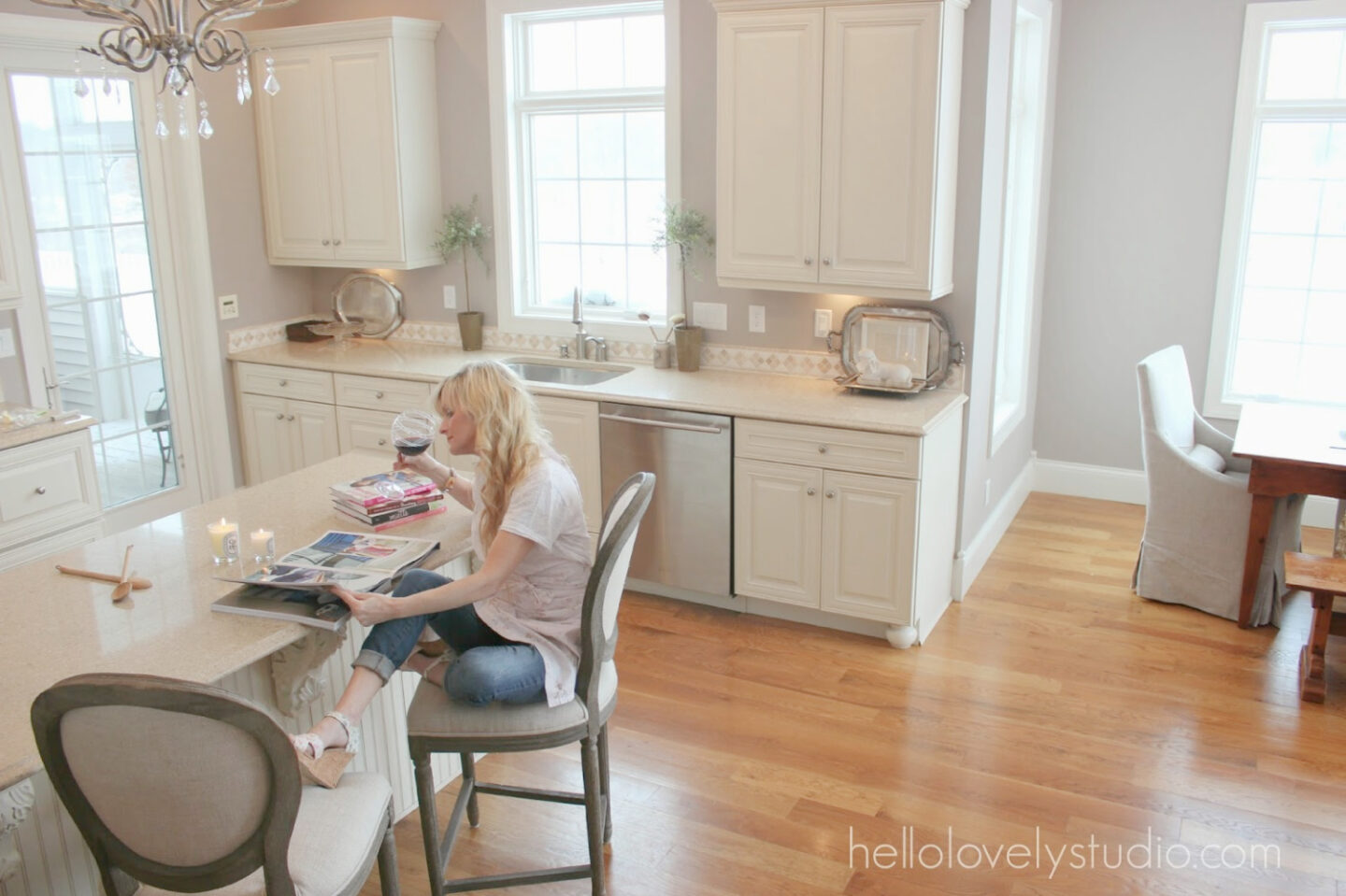 Ashley Gray (Benjamin Moore) in my French country kitchen with Silestone Ivory Coast counters, warm white Thomasville cabinets, and white oak hardwood flooring - Hello Lovely Studio. #bmashleygray #hellolovely #frenchkitchens