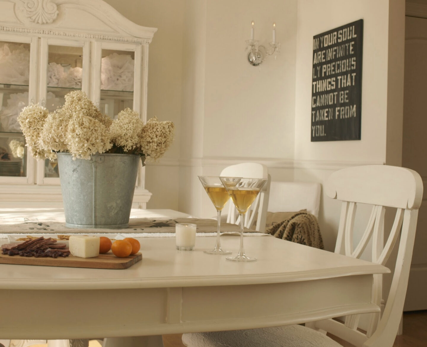 BM White Sand in our French country dining room with antique grainsack runner and galvanized bucket of hydrangea - Hello Lovely Studio. #hellolovely #bmwhitesand #frenchcountrywhites