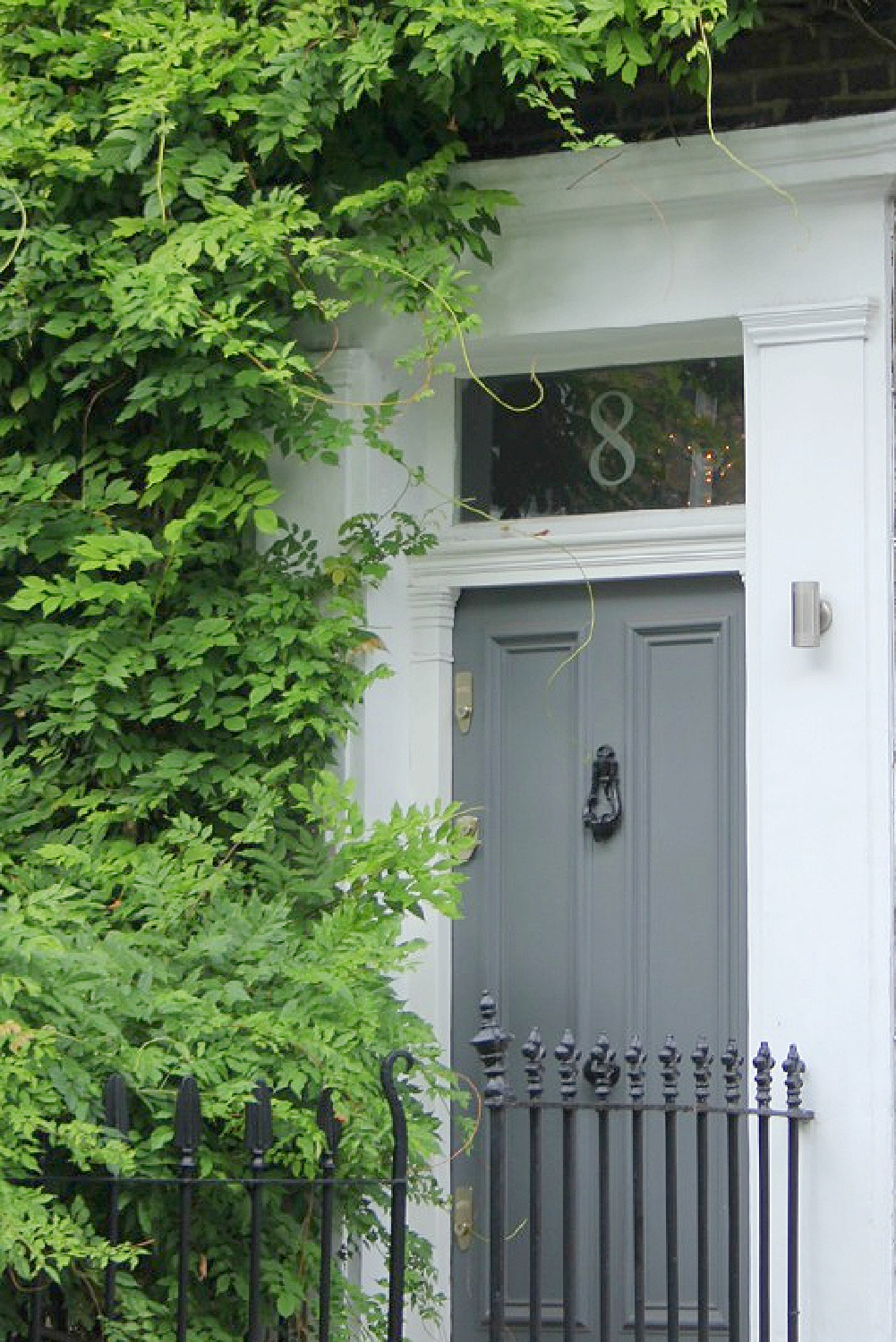 Beautiful sophisticated gray door and white trim on exterior in Notting Hill. Come explore paint colors for your front door. #frontdoorcolors #paintcolors #curbappeal