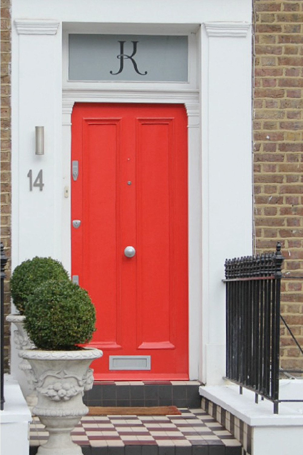 Bold red door with brick row house exterior in Notting Hill. Come explore paint colors for your front door. #frontdoorcolors #paintcolors #curbappeal