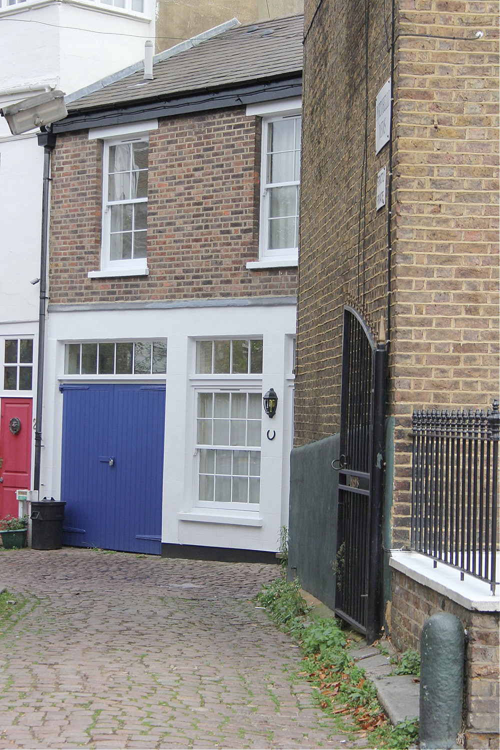 Bold blue stable doors and Mews exterior in Notting Hill. Come explore paint colors for your front door. #frontdoorcolors #paintcolors #curbappeal