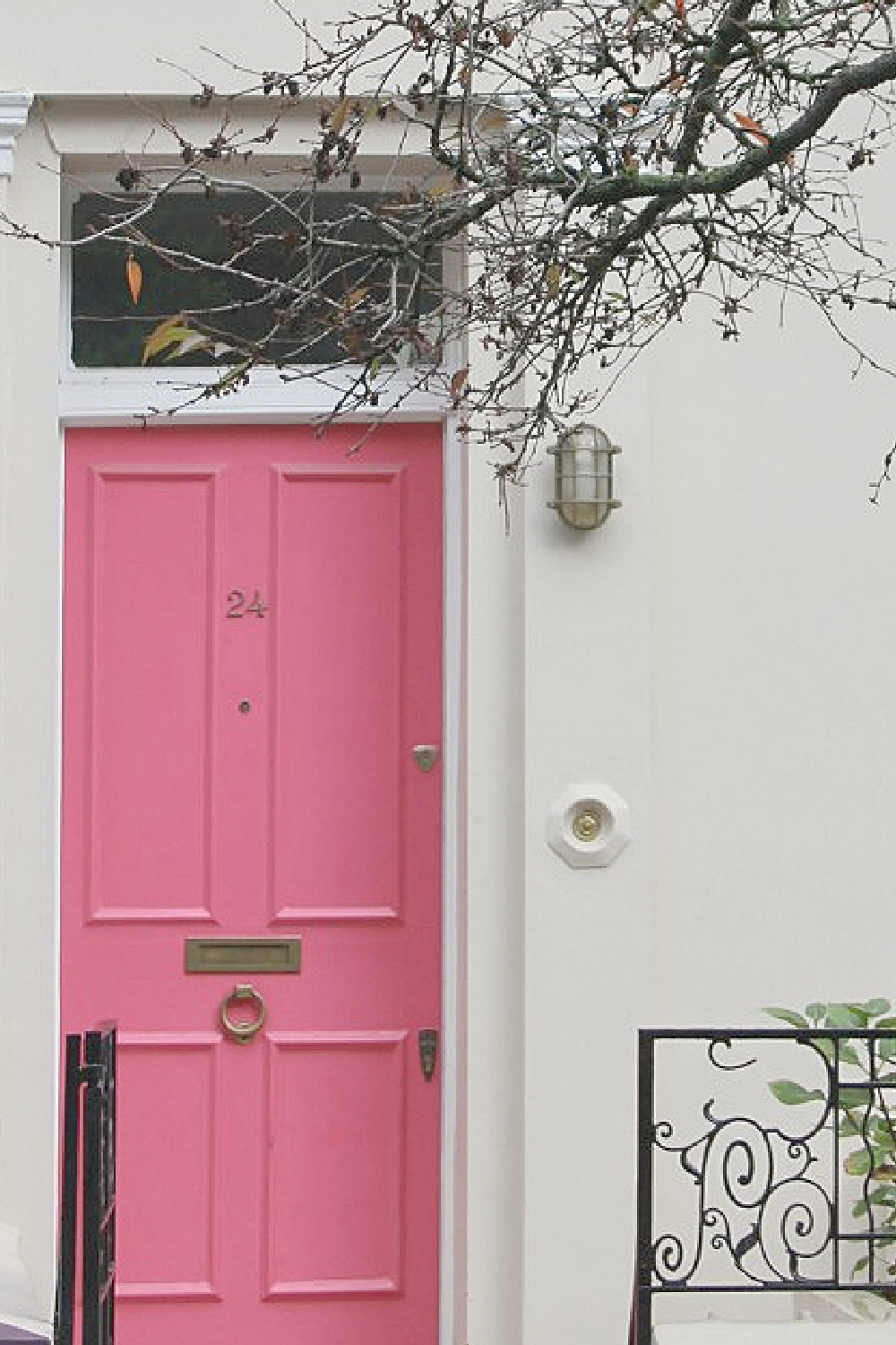 Barbie pink front door and white row house exterior in Notting Hill. Come explore paint colors for your front door. #frontdoorcolors #paintcolors #curbappeal