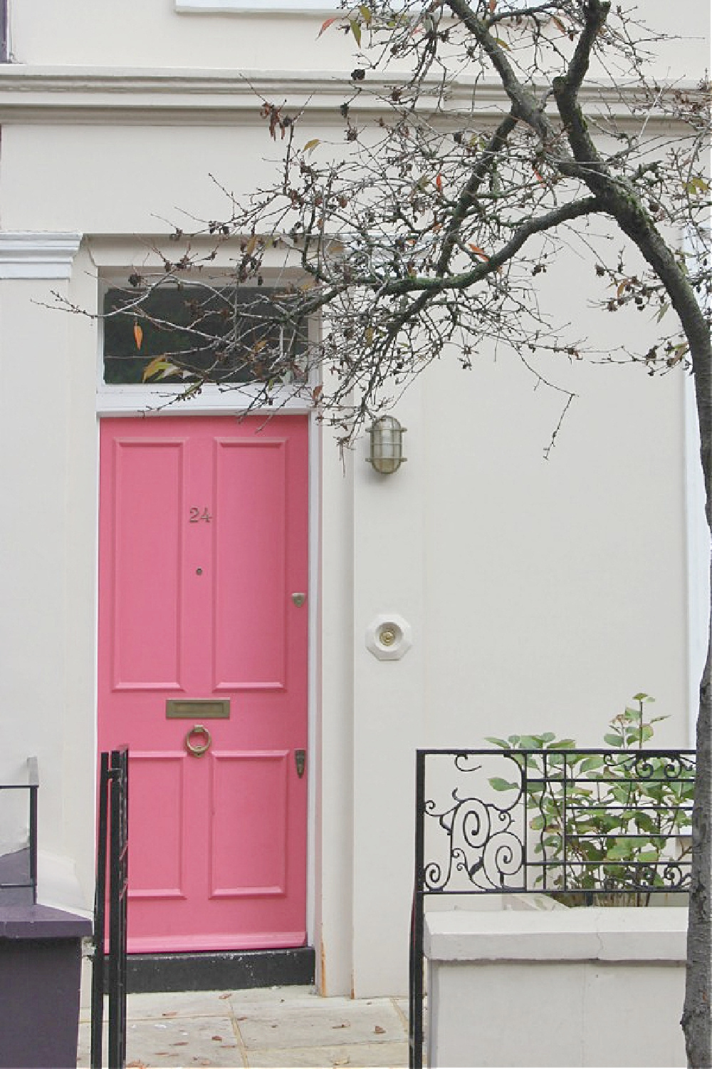 Barbie pink front door and white row house exterior in Notting Hill. Come explore paint colors for your front door. #frontdoorcolors #paintcolors #curbappeal