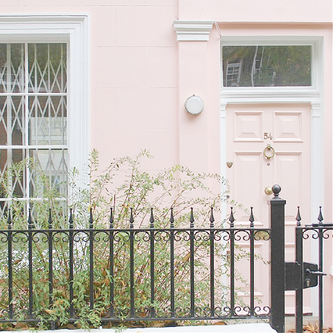 Pink row house with pink door in Notting Hill. Come explore paint colors for your front door. #frontdoorcolors #paintcolors #curbappeal