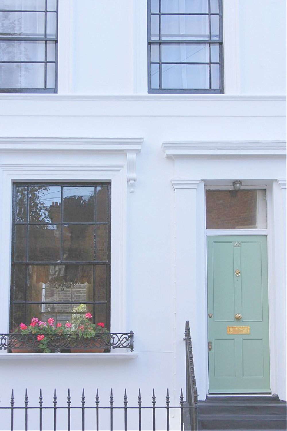 Gorgeous French green door with black trim on white row house in Notting Hill. Come explore paint colors for your front door. #frontdoorcolors #paintcolors #curbappeal