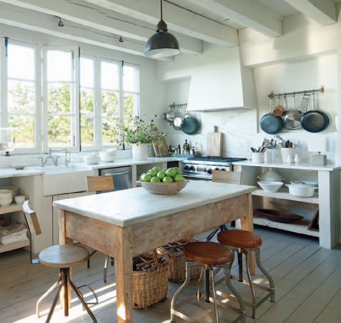 Modern French kitchen designed by Eleanor Cummings (Kirby Mears, architect) with rustic work table, industrial elements, and lower cabinets without doors - photo by Tim Street Porter. #modernfrench #frenchkitchen