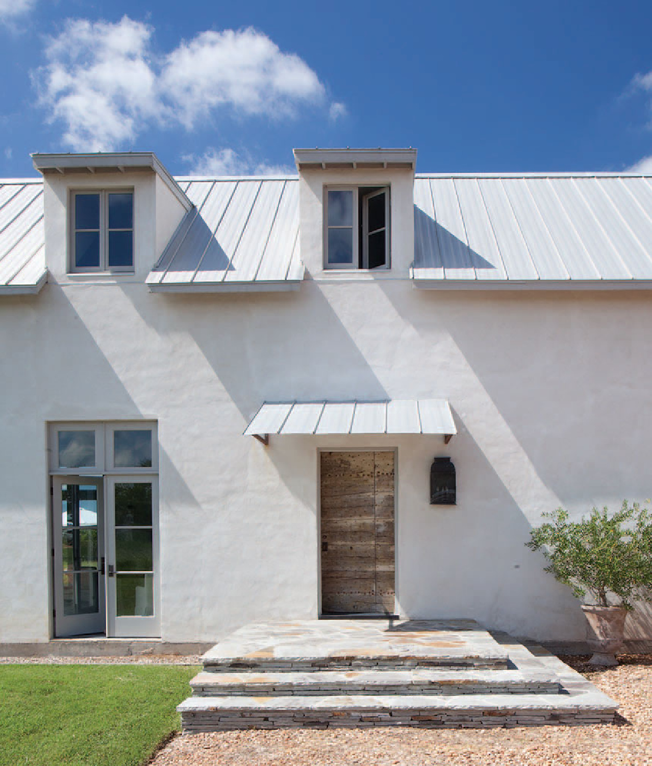 Modern French farmhouse exterior of home near Round Top, TX, designed by Kirby Mears for Eleanor Cummings, interior designer.