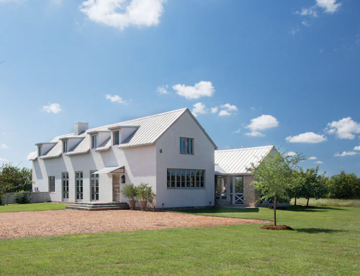 Modern French farmhouse exterior of home near Round Top, TX, designed by Kirby Mears for Eleanor Cummings, interior designer.