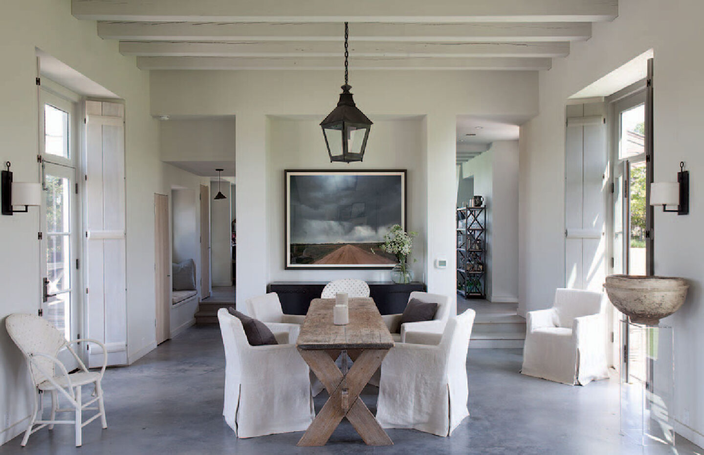 Modern French farmhouse dining area with antique orchard table in home near Round Top, TX, designed by Kirby Mears for Eleanor Cummings, interior designer.