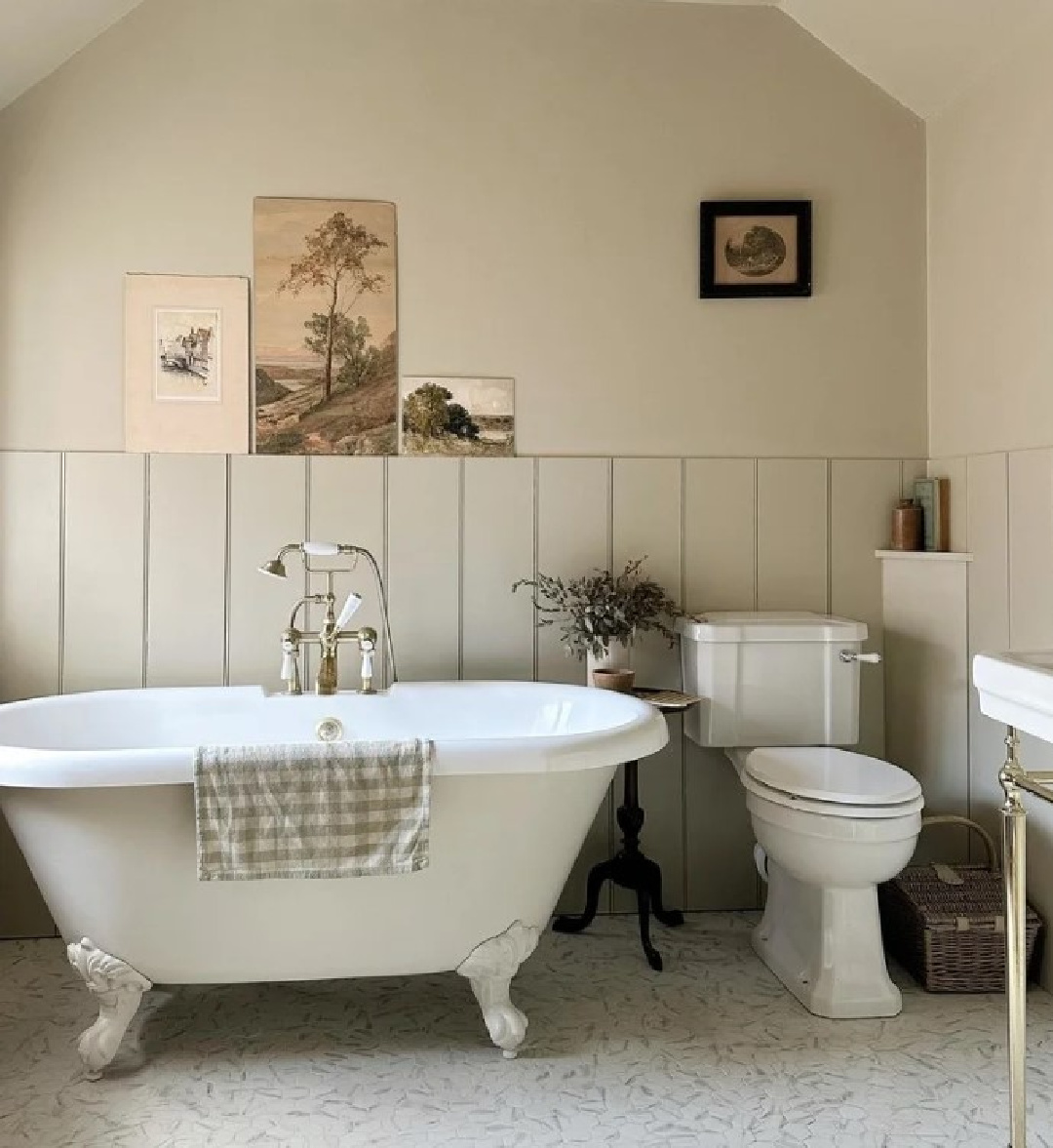 Farrow & Ball Old White paint in English country bathroom with clawfoot tub and vintage sepia artwork - @harnhamhouse. #oldwhite #farrowandballoldwhite