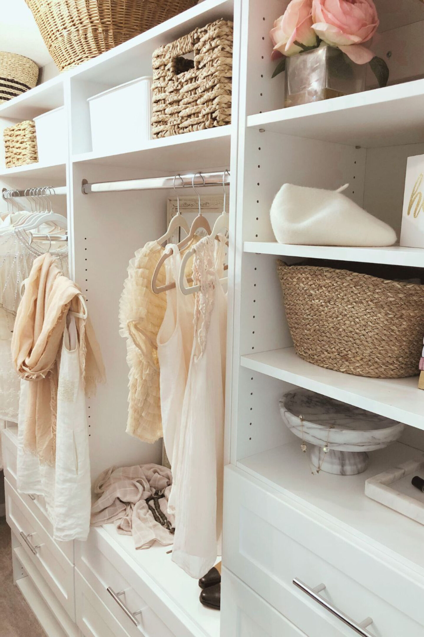 Hello Lovely's before & after walk-in closet shares a custom closet DIY with white Shaker style towers and drawers from Modular Closets. This his and hers closet makes the most of every inch. #closetupgrades #diycloset #customclosetideas #closetmakeover #closetmodules #diyclosetmakeover