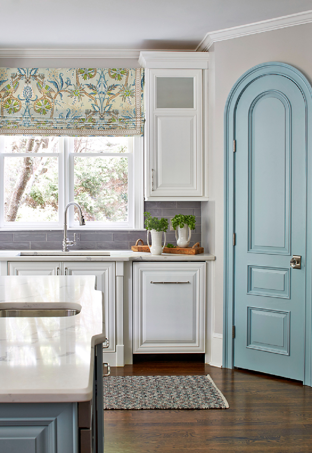 SW Atmospheric (turquoise blue) accents in a Kandrac & Kole designed kitchen with turquoise island and arched pantry door. Walls are SW Repose Gray. #bmatmospheric #reposegray #turquoisekitchen