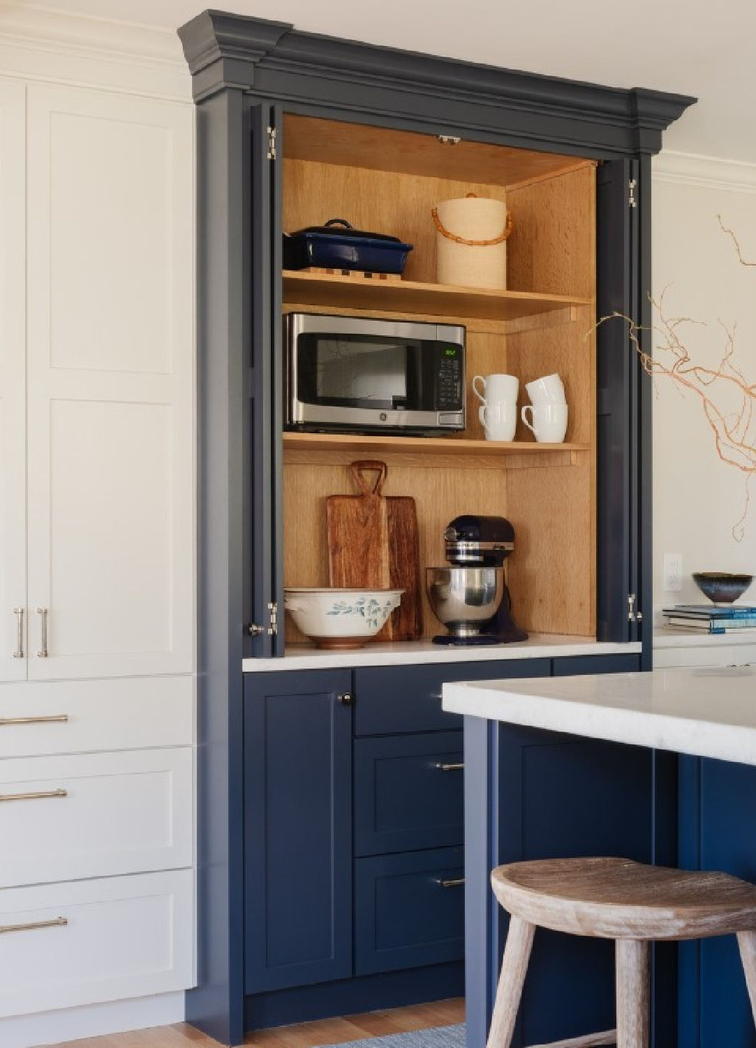 Navy blue painted built-in pantry cabinet in a beautiful white kitchen - @bethbourque. #navybluekitchen #twotonekitchens