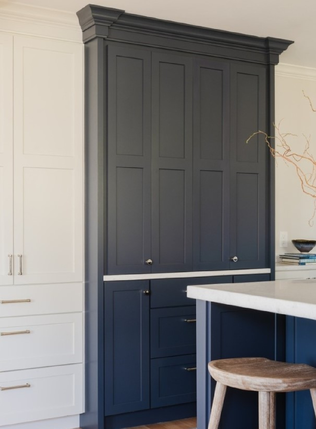 Navy blue painted built-in pantry cabinet in a beautiful white kitchen - @bethbourque. #navybluekitchen #twotonekitchens