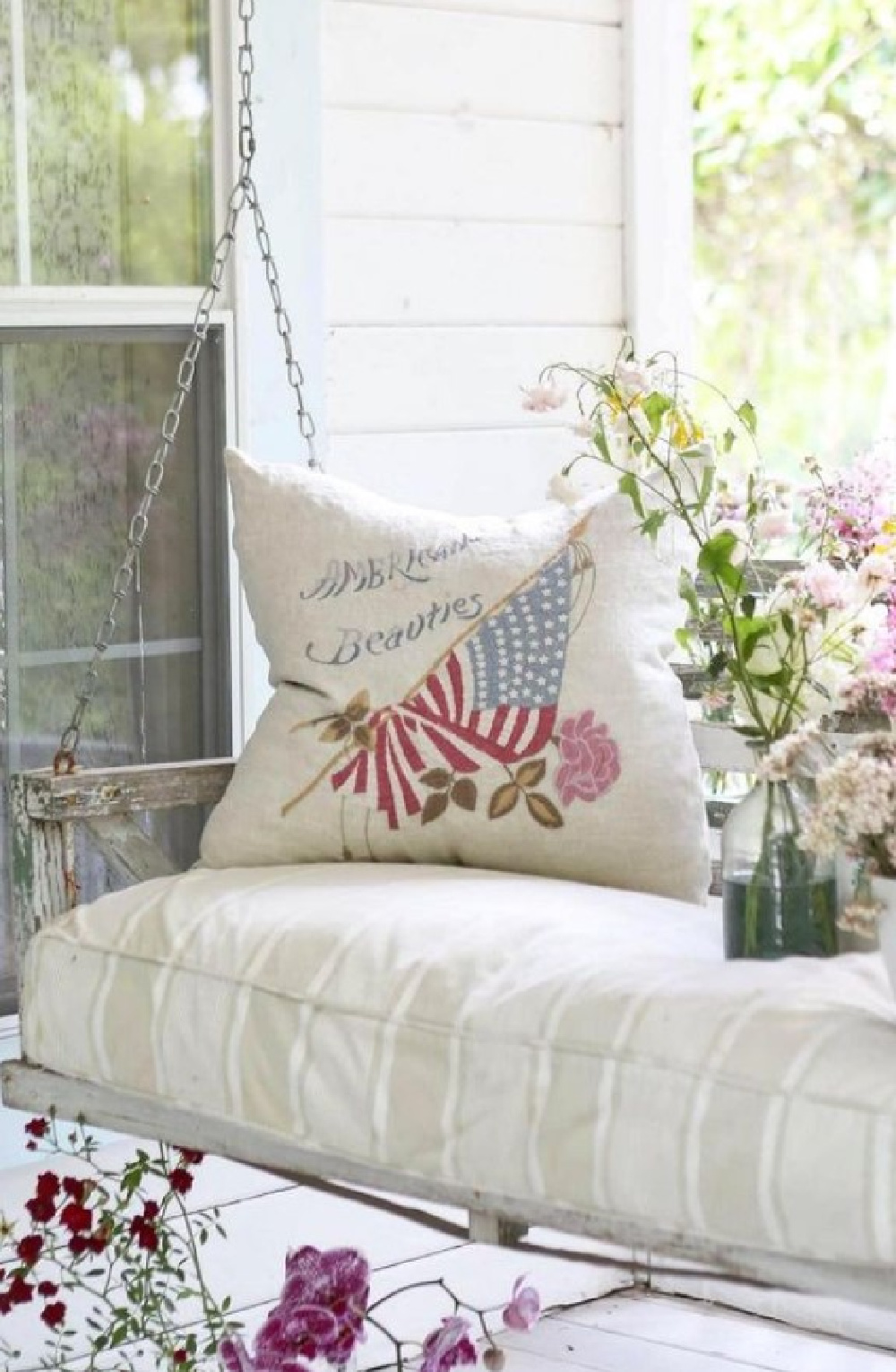 Vintage American Beauties pillow on a porch swing with a sumptuous cushion - Rachel Ashwell Shabby Chic. #porchswings #vintagepillows