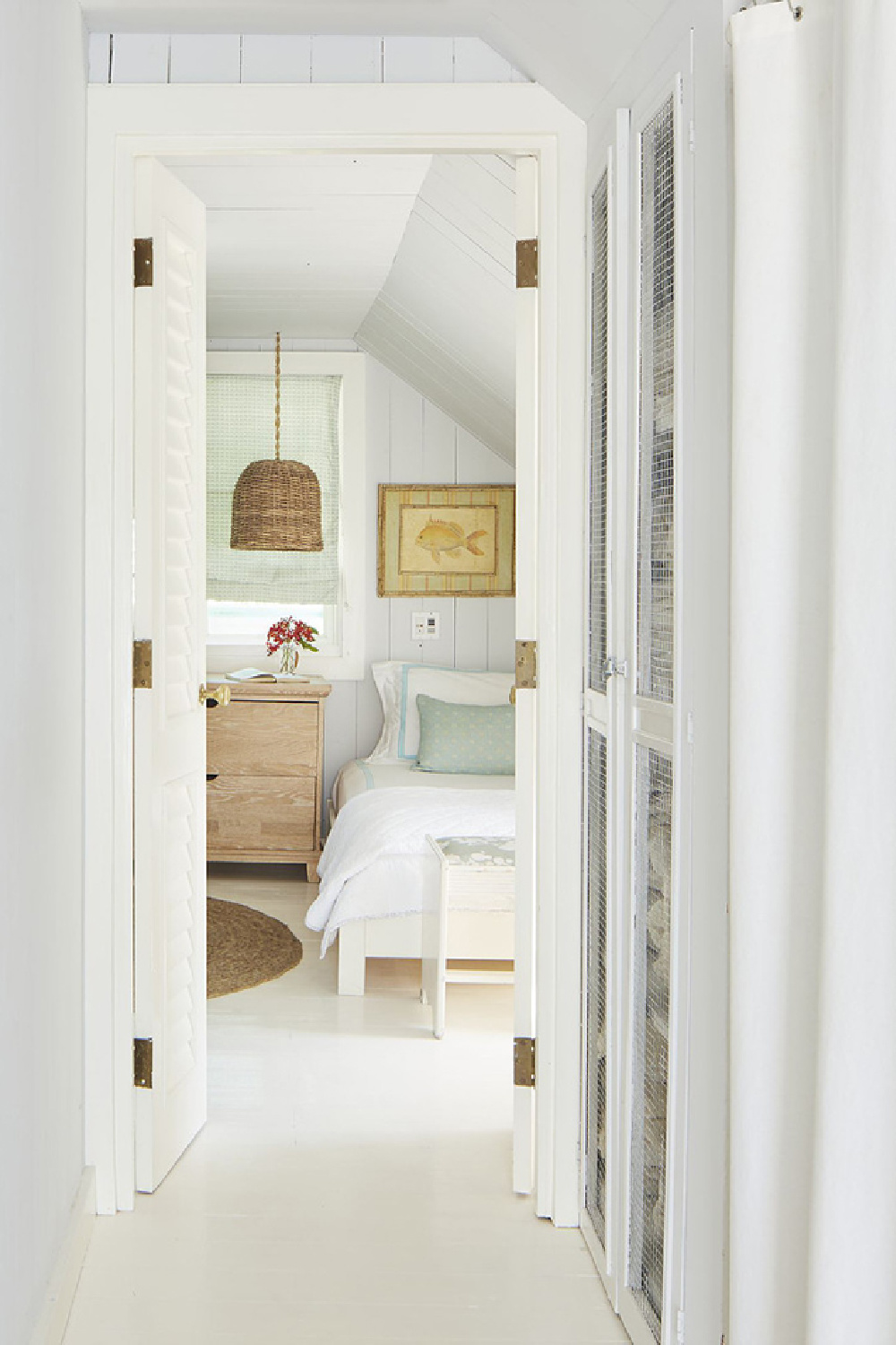 Tranquil muted blue bedroom in Bahamas with design by Trish Becker for Coastal Living - photo by Annie Schlechter. #coastalbedroom #paleblue