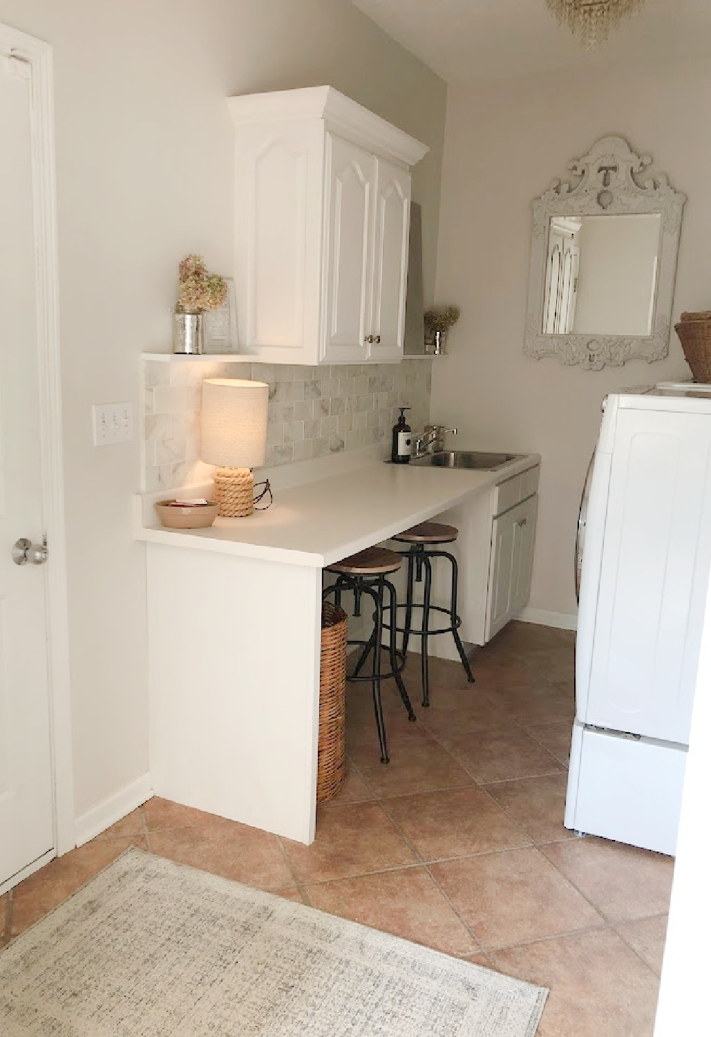 Laundry room with Amber Lewis Loloi Zuma rug on terracotta tile - Hello Lovely Studio.