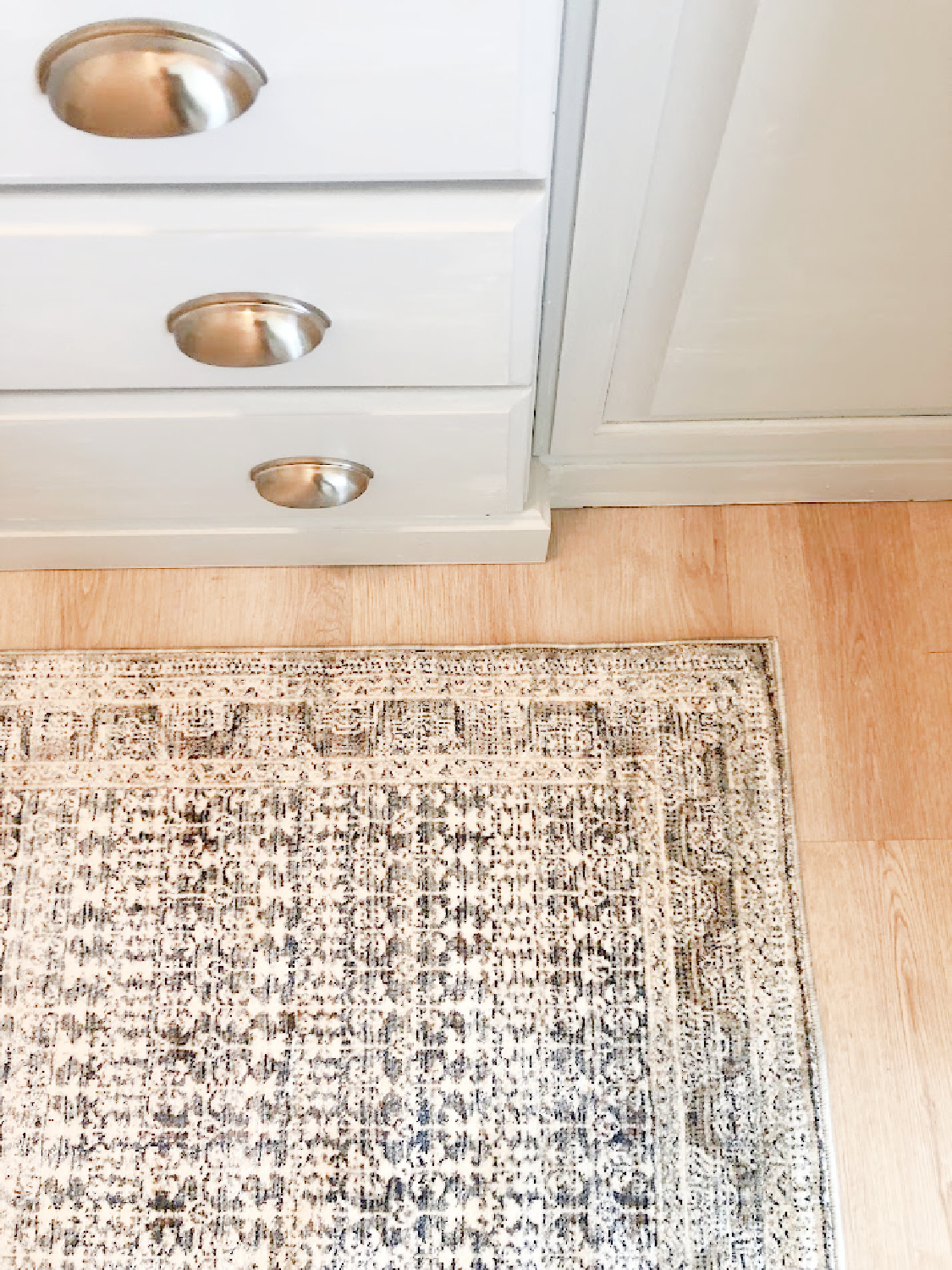 Zuma rug (Amber Lewis/Loloi) in my pantry with light grey cabinets in my modern French kitchen - Hello Lovely Studio.