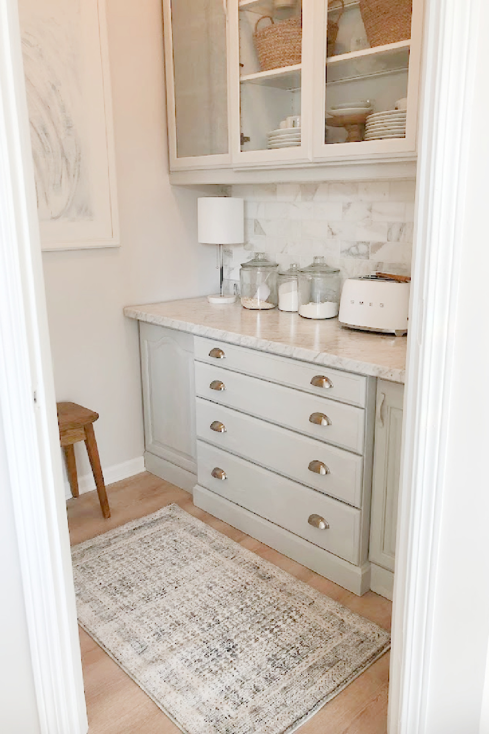 Zuma rug (Amber Lewis/Loloi) in my pantry with light grey cabinets in my modern French kitchen - Hello Lovely Studio.