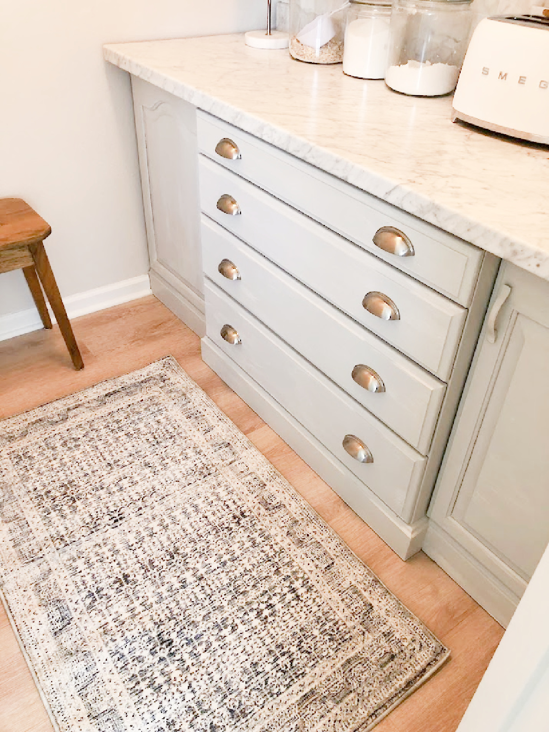 Zuma rug (Amber Lewis/Loloi) in my pantry with light grey cabinets in my modern French kitchen - Hello Lovely Studio.