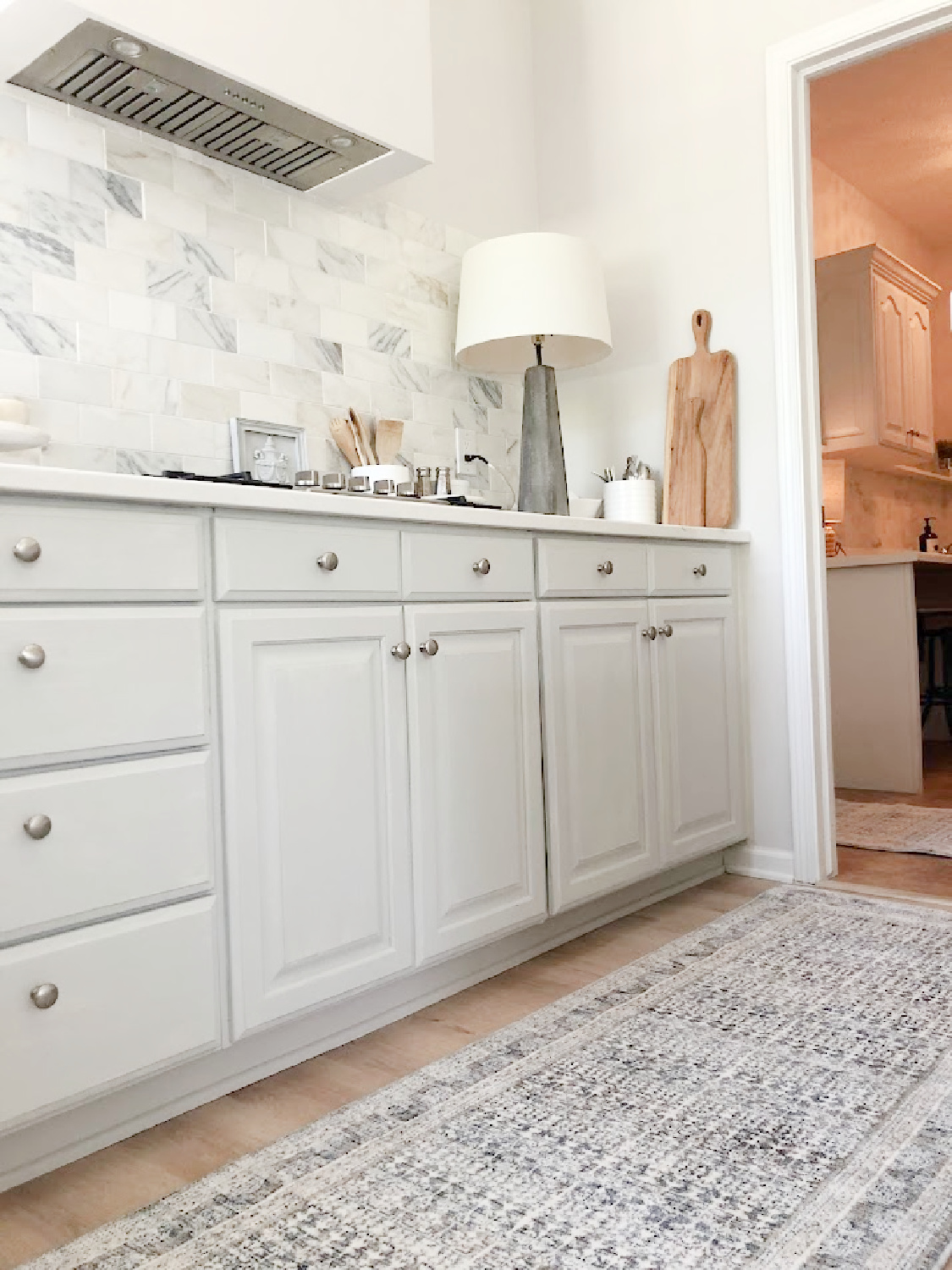 Amber Lewis x Loloi runner rug in my modern French kitchen with Calacatta Gold marble tile backsplash - Hello Lovely Studio. #modernfrench #greykitchens #viateramuse