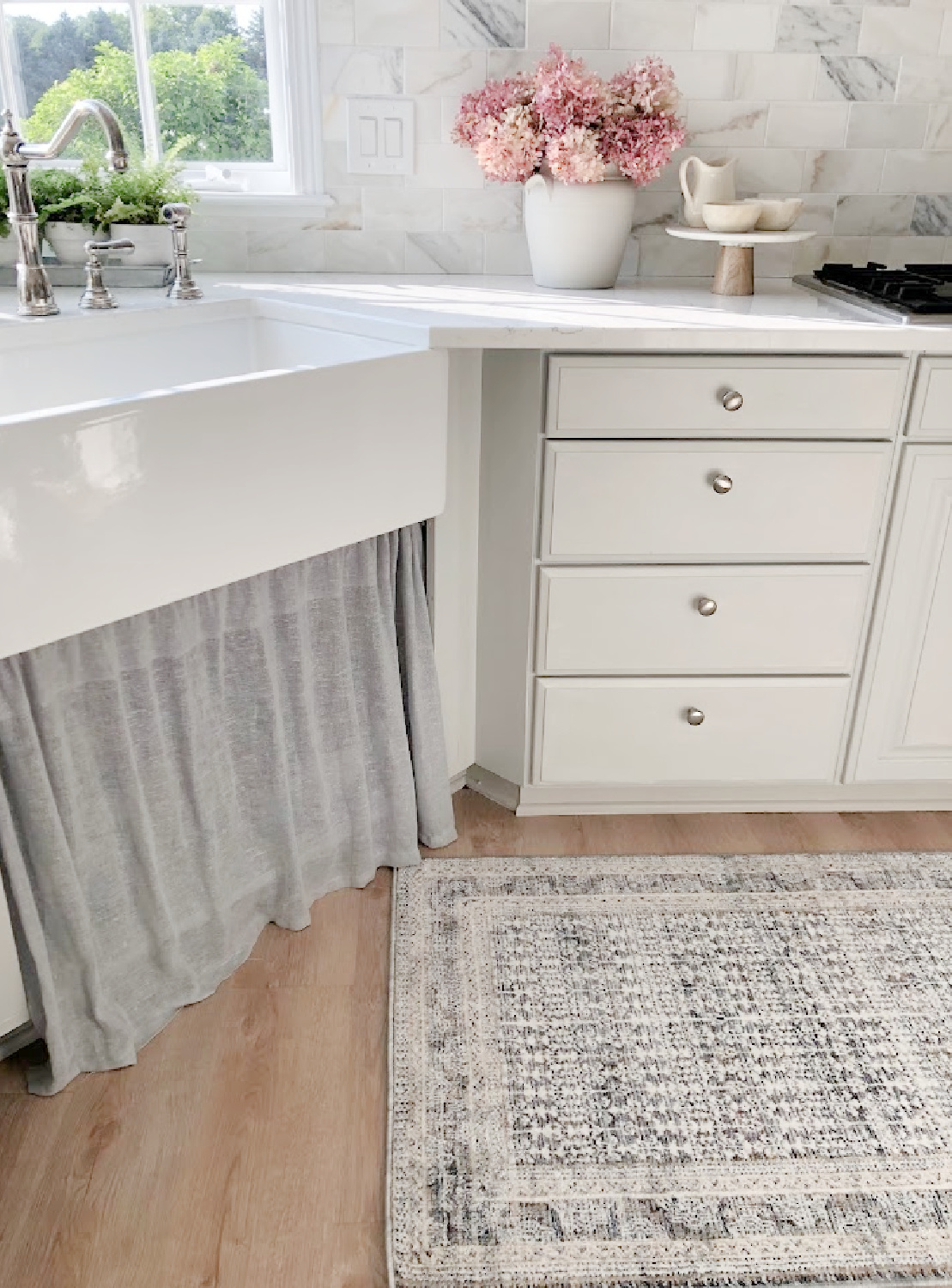 Farm sink with skirted sink base and Loloi x Amber Lewis Zuma rug (ocean) in my modern French kitchen - Hello Lovely Studio.