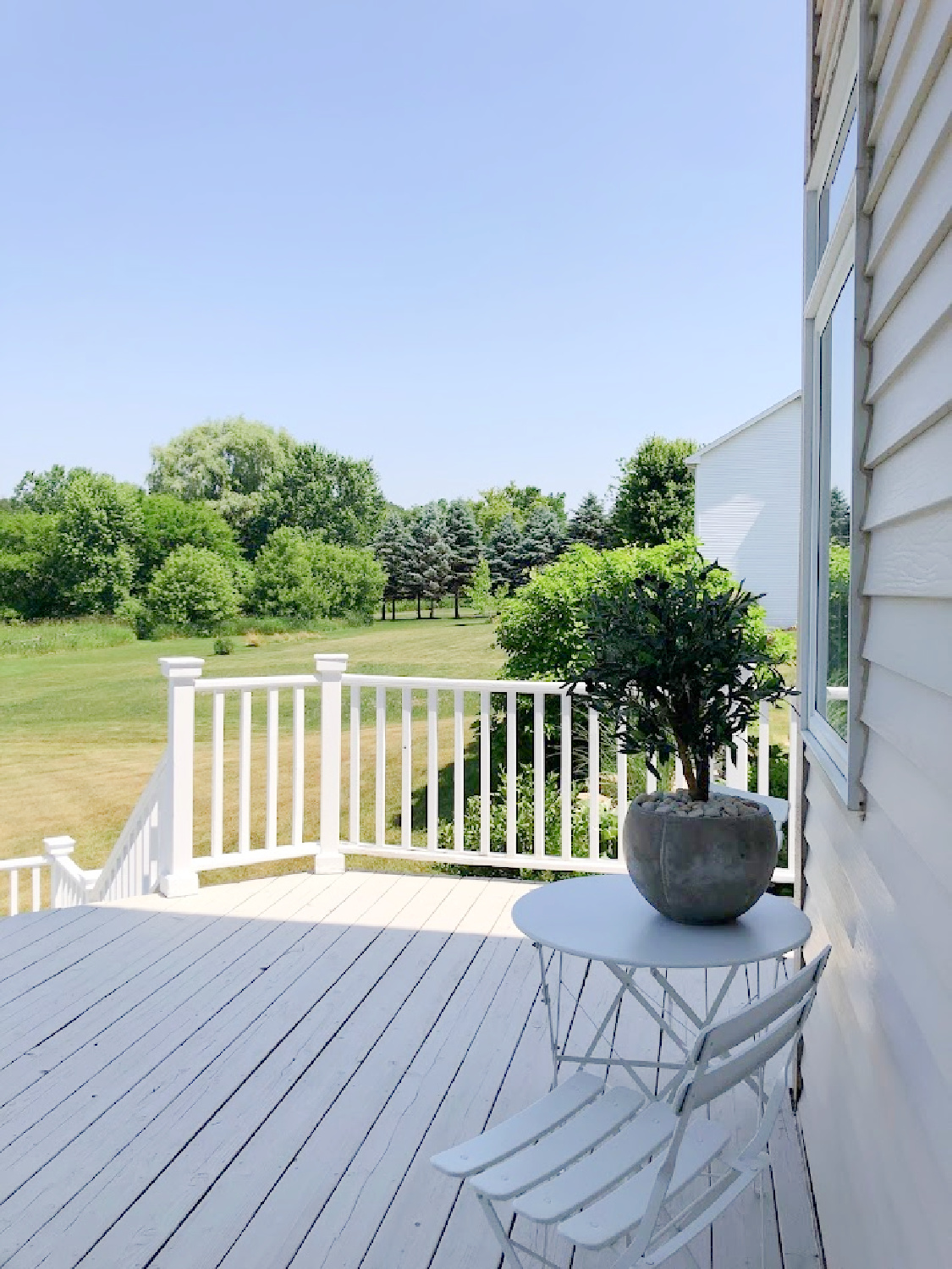 Deck with stone/grey and white railing at the Georgian - Hello Lovely Studio.