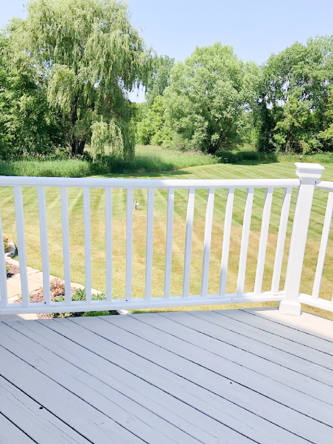 Deck with stone/grey and white railing at the Georgian - Hello Lovely Studio.