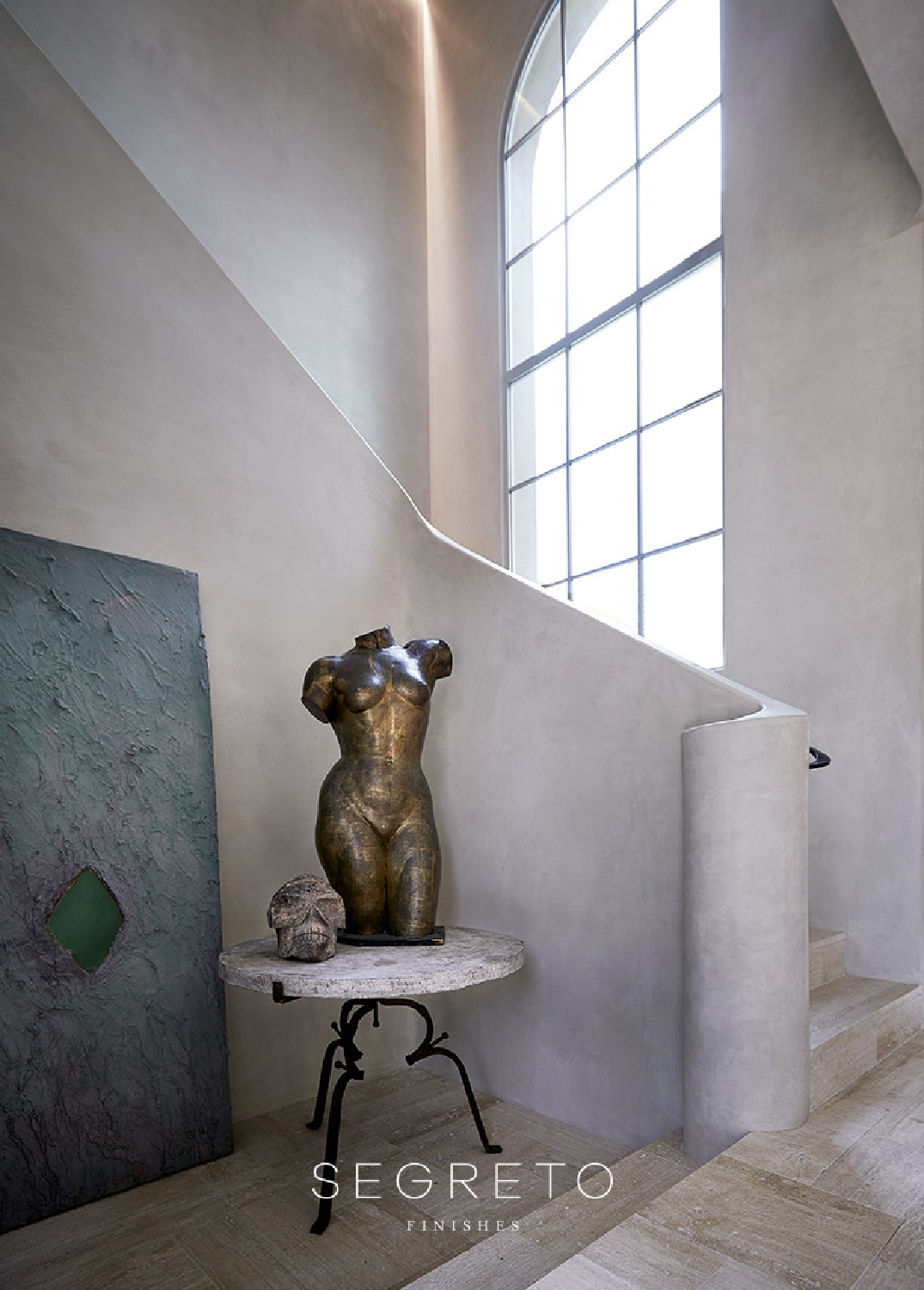 Sculptural staircase with beautiful plaster work by Segreto Finishes.