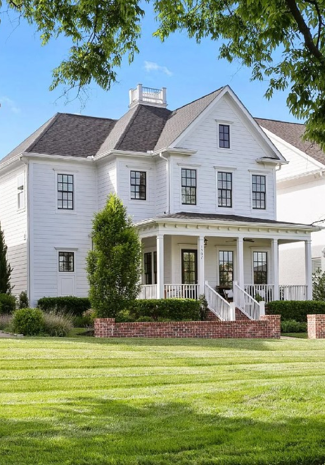 Beautiful white farmhouse with front porch on Eliot Rd. in Franklin, TN.