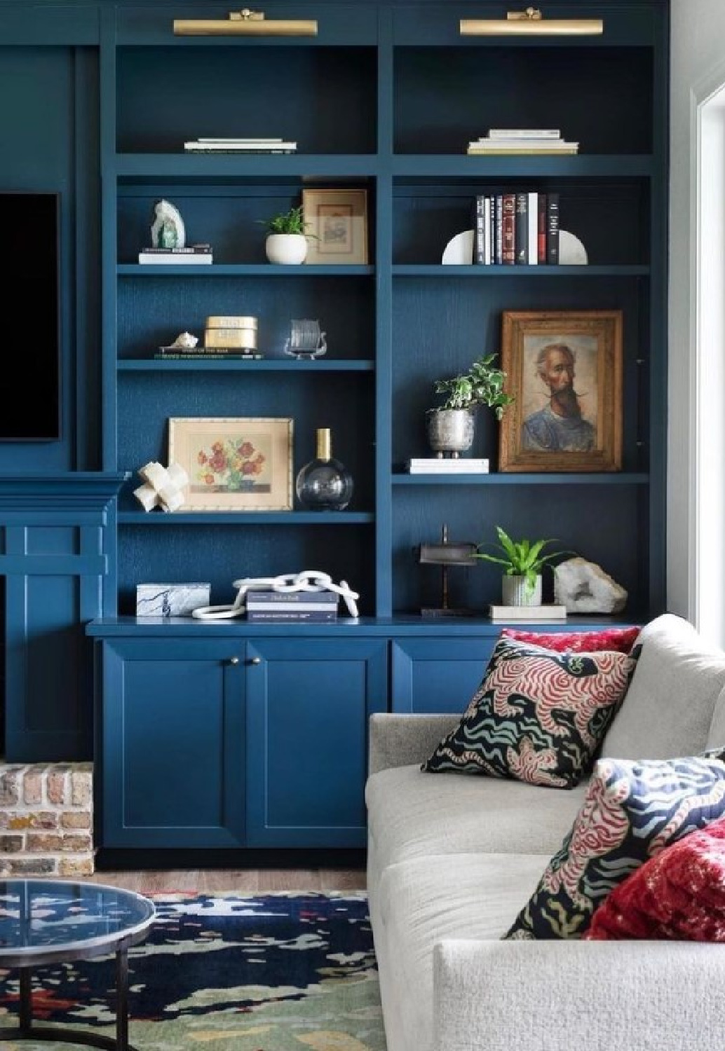 Farrow & Ball Hague Blue on built-in shelves in a family room with sofa. #hagueblue #bestmoodybluepaintcolors