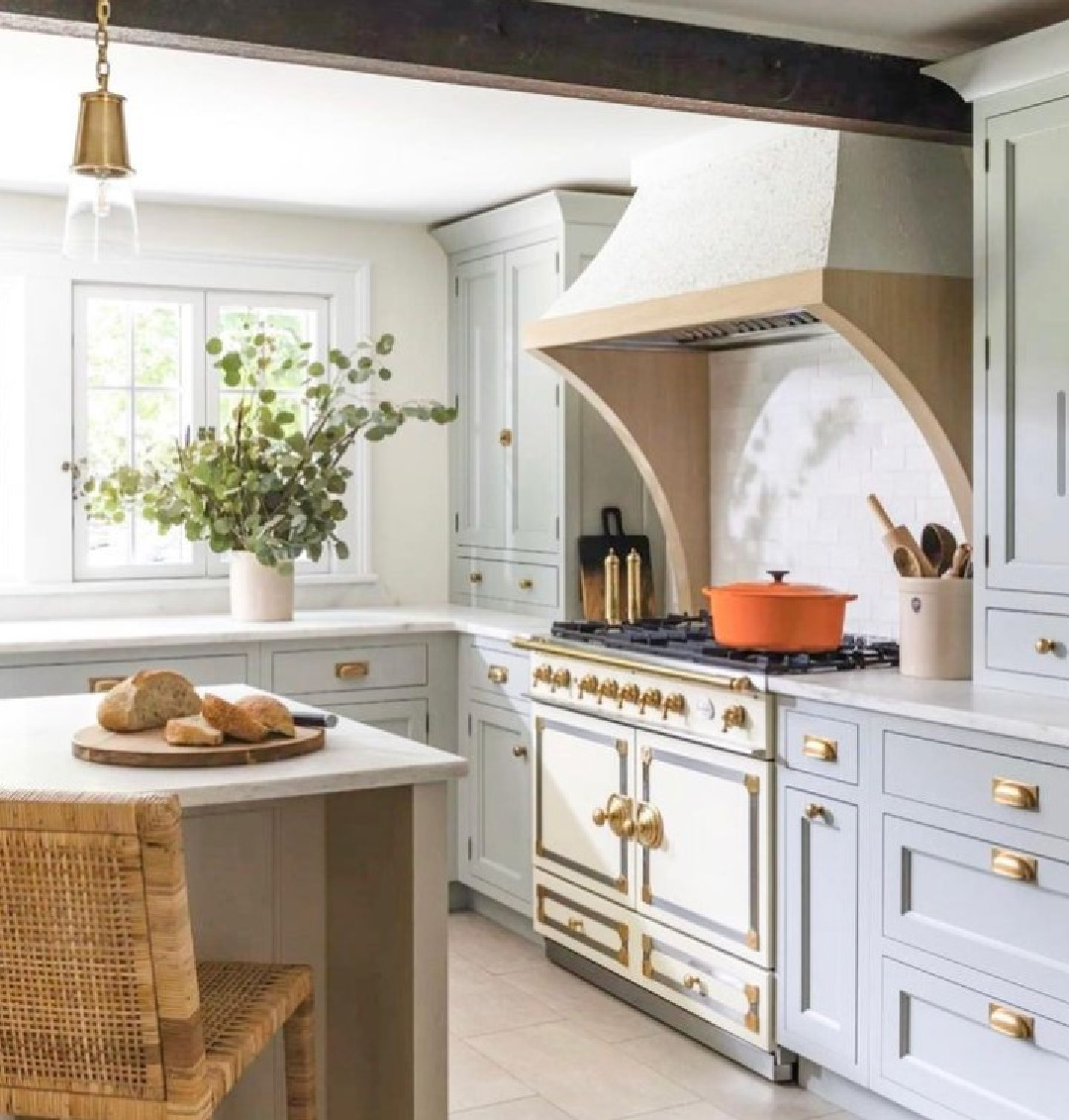 Beautiful modern European country kitchen with French range and Farrow & Ball Light Blue painted cabinets - @bilottakitchens. #farrowandballlightblue #bluekitchens #modernfrench