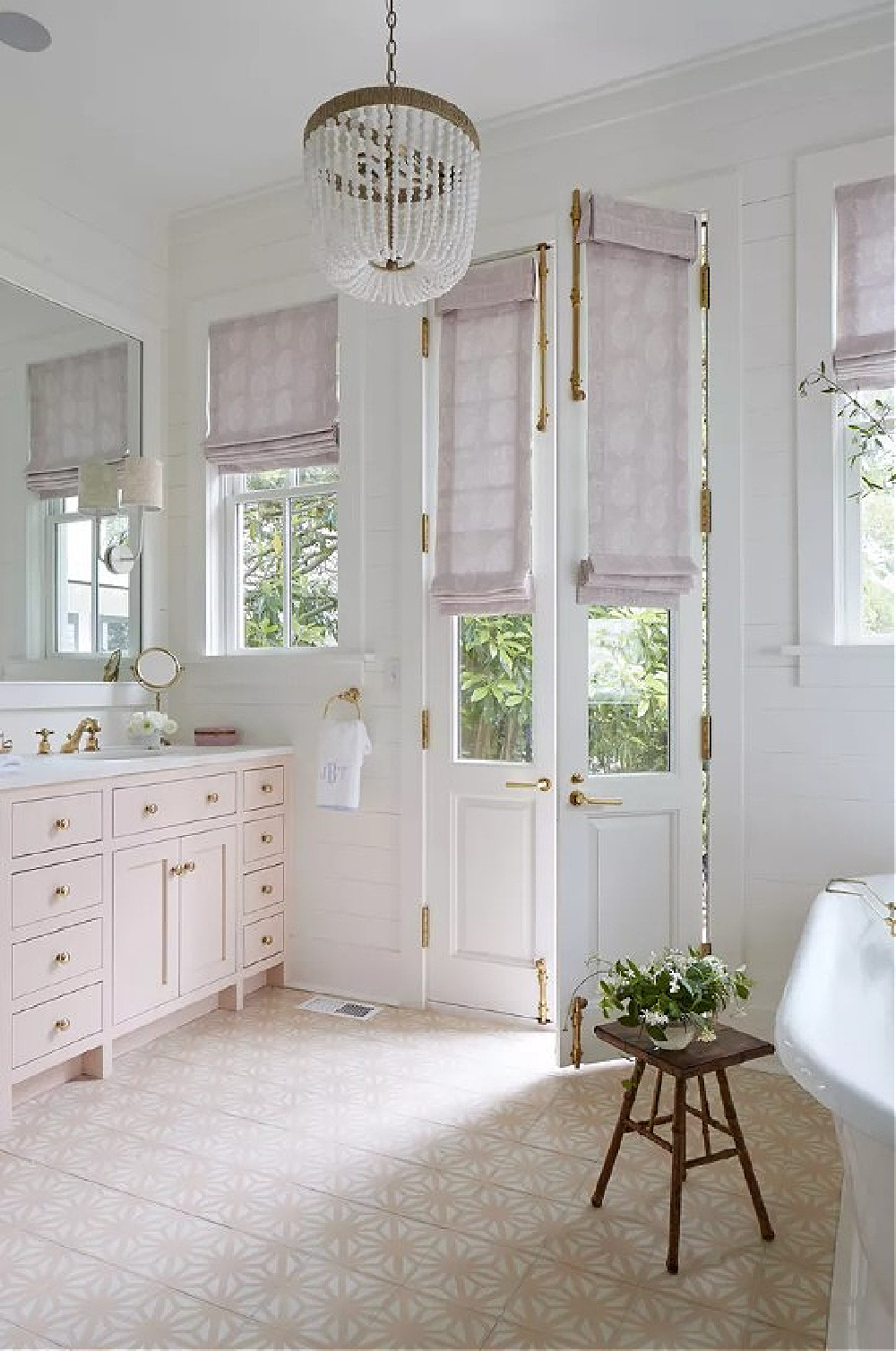 Pink bathroom with vanity (Farrow & Ball Pink Ground), lavender roman shades, and pink cement tiles - Julia Berolzheimer's home in Southern Living (photo: Hector Manuel Sanchez). #pinkground #pinkbathroom #traditionalstyle