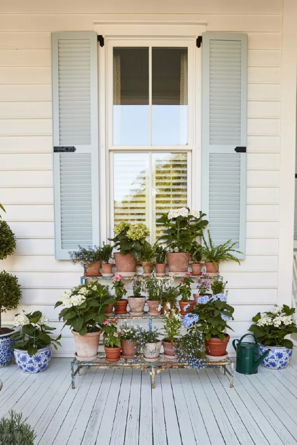 BM Blue Porcelain shutters and Simply White siding on a charming Charleston exterior - Julia Berolzheimer's home in Southern Living (photo: Hector Manuel Sanchez). #bmsimplywhite #bmblueporcelain