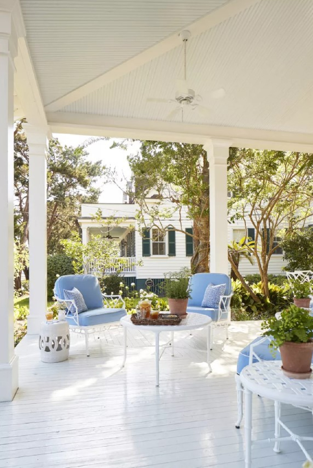 Haint blue ceiling on front porch with patio furniture and blue cushions - Julia Berolzheimer's home in Southern Living (photo: Hector Manuel Sanchez). #bmsimplywhite
