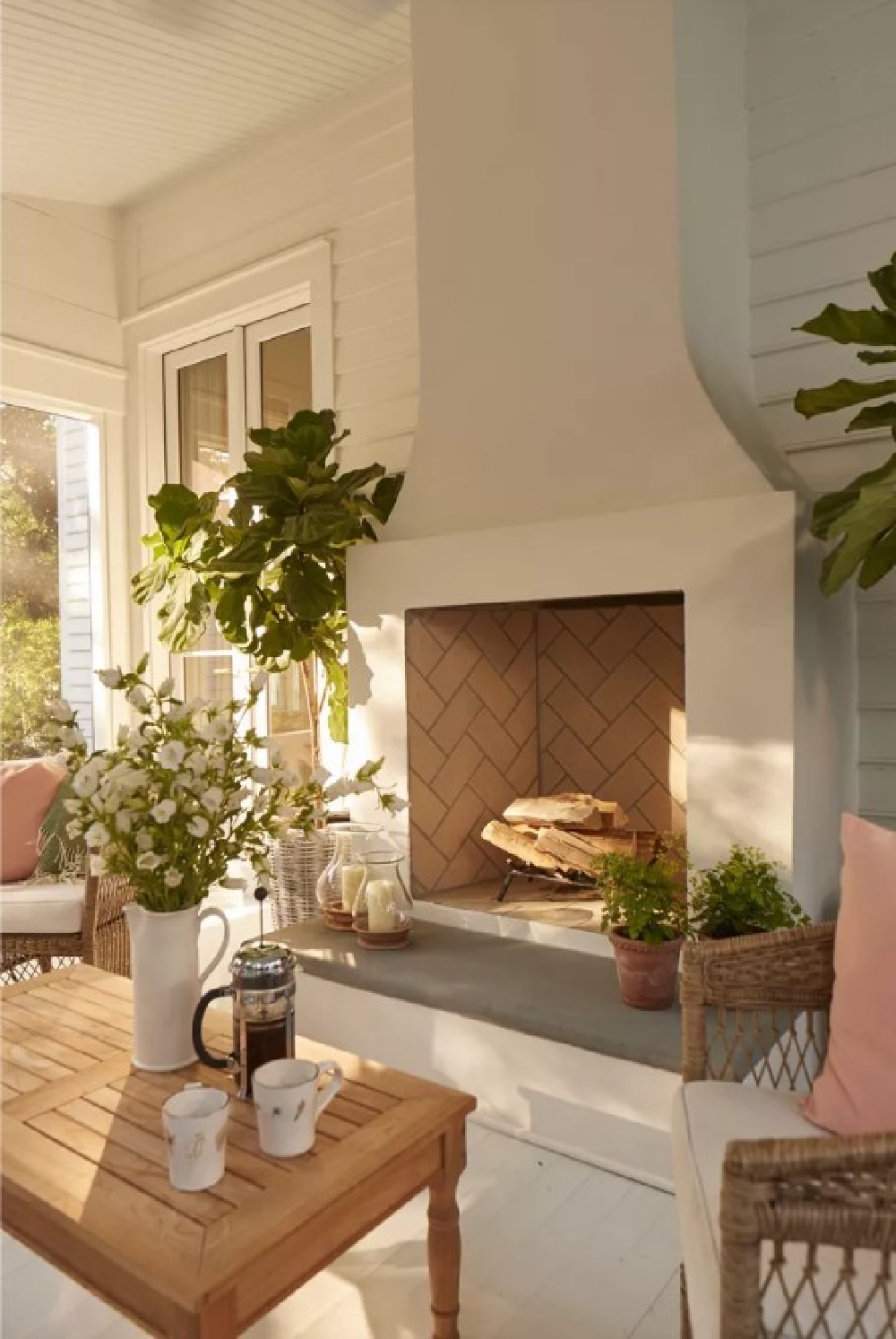 Screen porch with fireplace in charming Charleston home - Julia Berolzheimer's home in Southern Living (photo: Hector Manuel Sanchez). #screenporchdesign