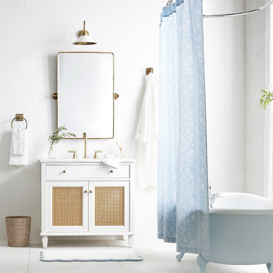Classic white bath vanity set (cane doors) with pivot mirror and Julia Berolzheimer scalloped bath mat -Pottery Barn. #bathroomdesign #classicwhitebath