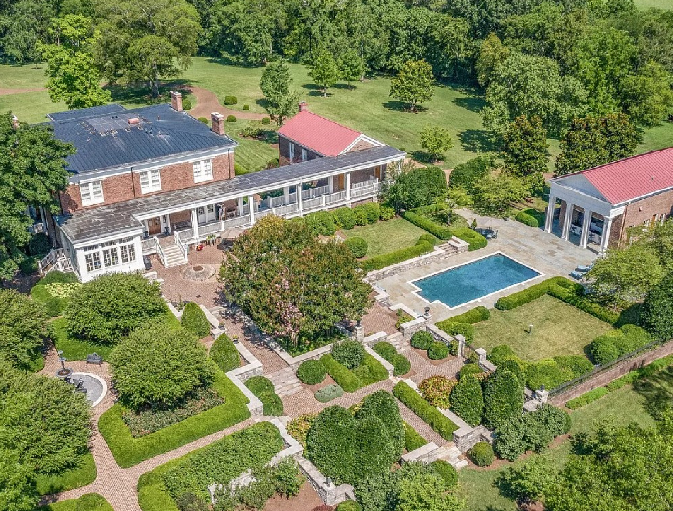 Stunning aerial view of a beautiful 1836 property in Franklin, TN (Old Hillsboro) with formal gardens and pool.