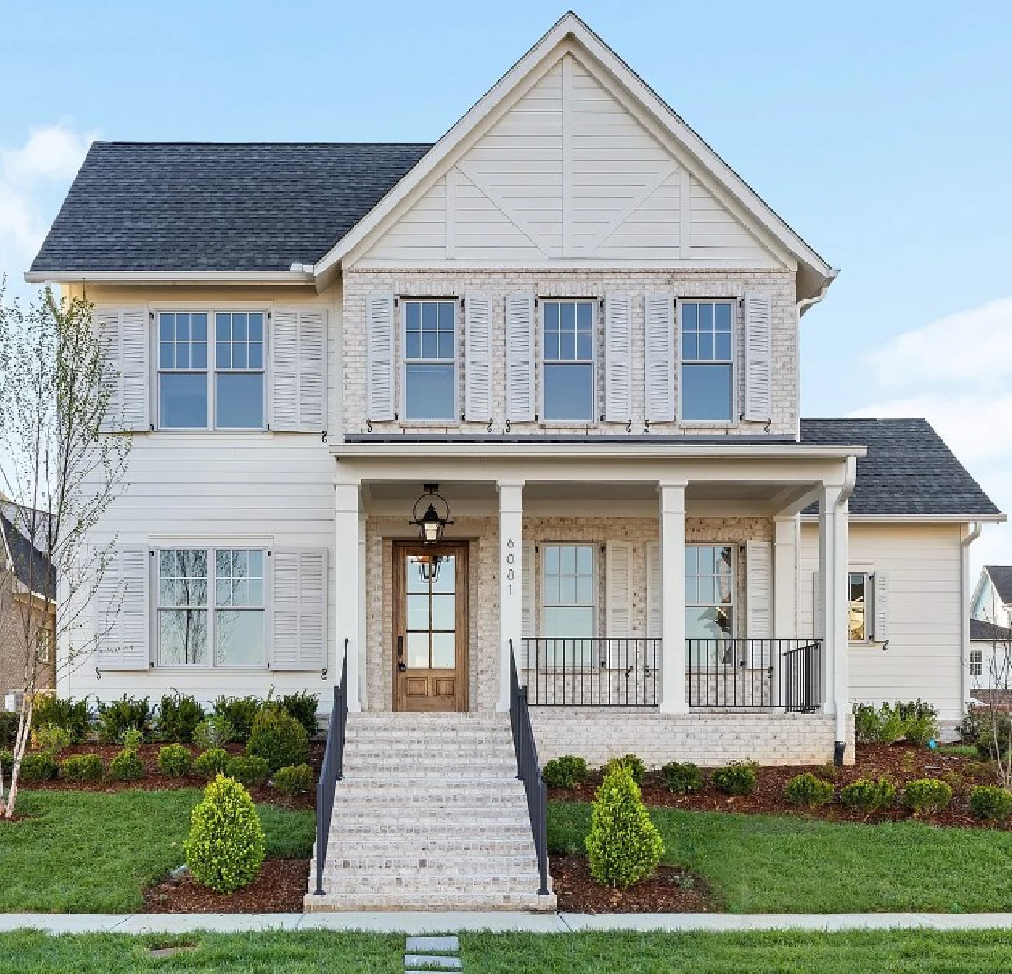 Beautiful white farmhouse exterior with brick, shutters, and haint blue ceiling on porch - Pasquo Rd. in Franklin, TN. #modernfarmhouseexterior