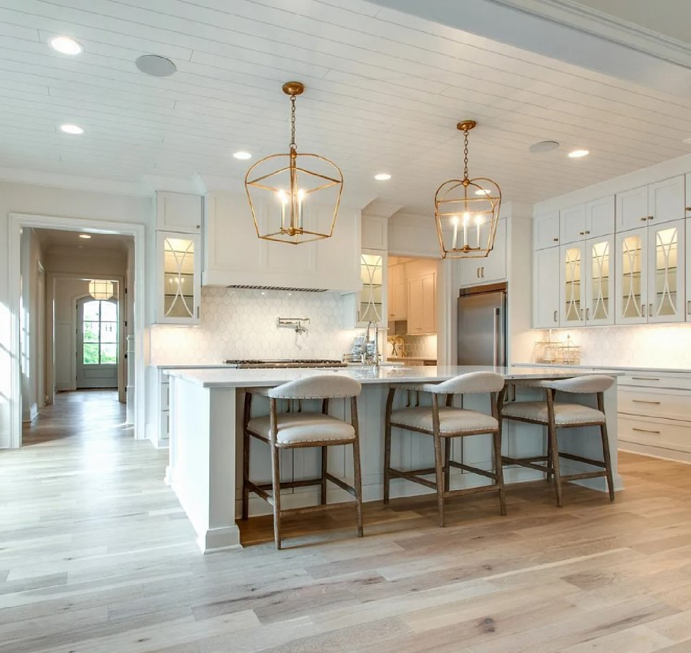 Classic and beautiful white kitchen with island and warm wood floors in a Sipple Home on Pasquo in Franklin, TN.