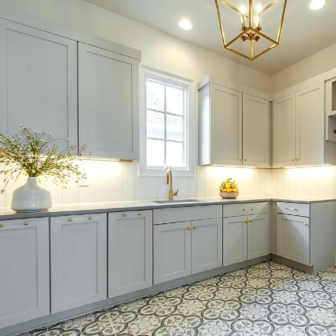 Gorgeous light blue grey laundry room with gold lantern pendant in a Sipple Home on Pasquo in Franklin, TN. #laundryrooms