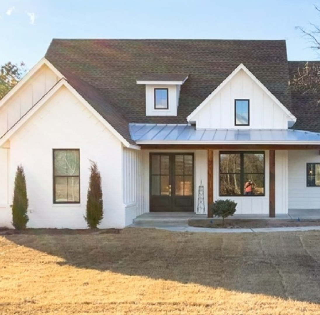 @adhouseplans - SW Pure White 7005 on a beautiful modern farmhouse house exterior. #swpurewhite #whitehouseexterior #whitefarmhouses