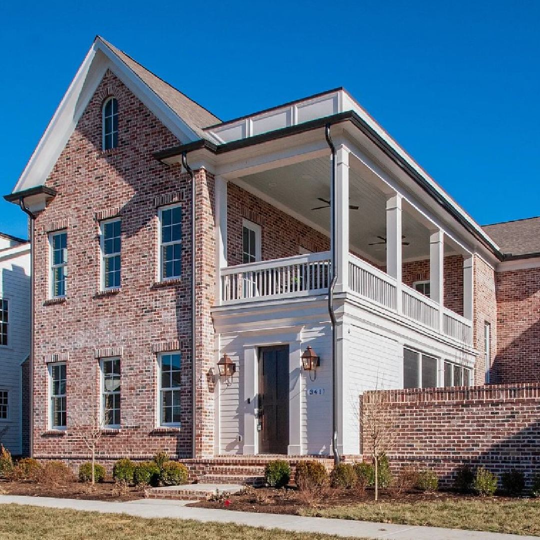 Beautiful Franklin, TN red brick Charleston style house exterior on Stephens Valley. #charlestonstyle #houseexteriors #piazzas