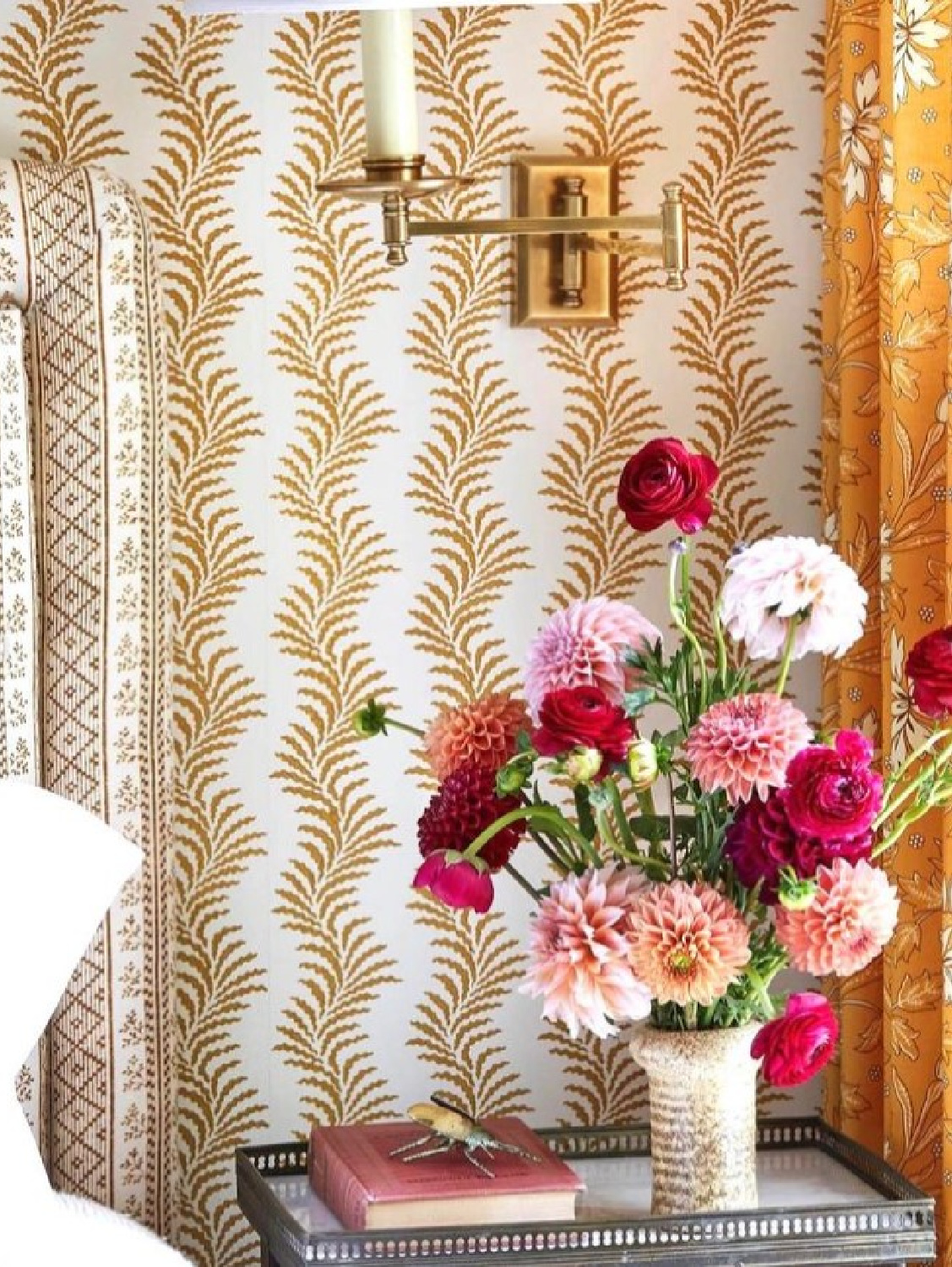 Summer Thornton designed bedroom with marigold wallpaper and bright pink floral arrangement. #bedroomwallpaper