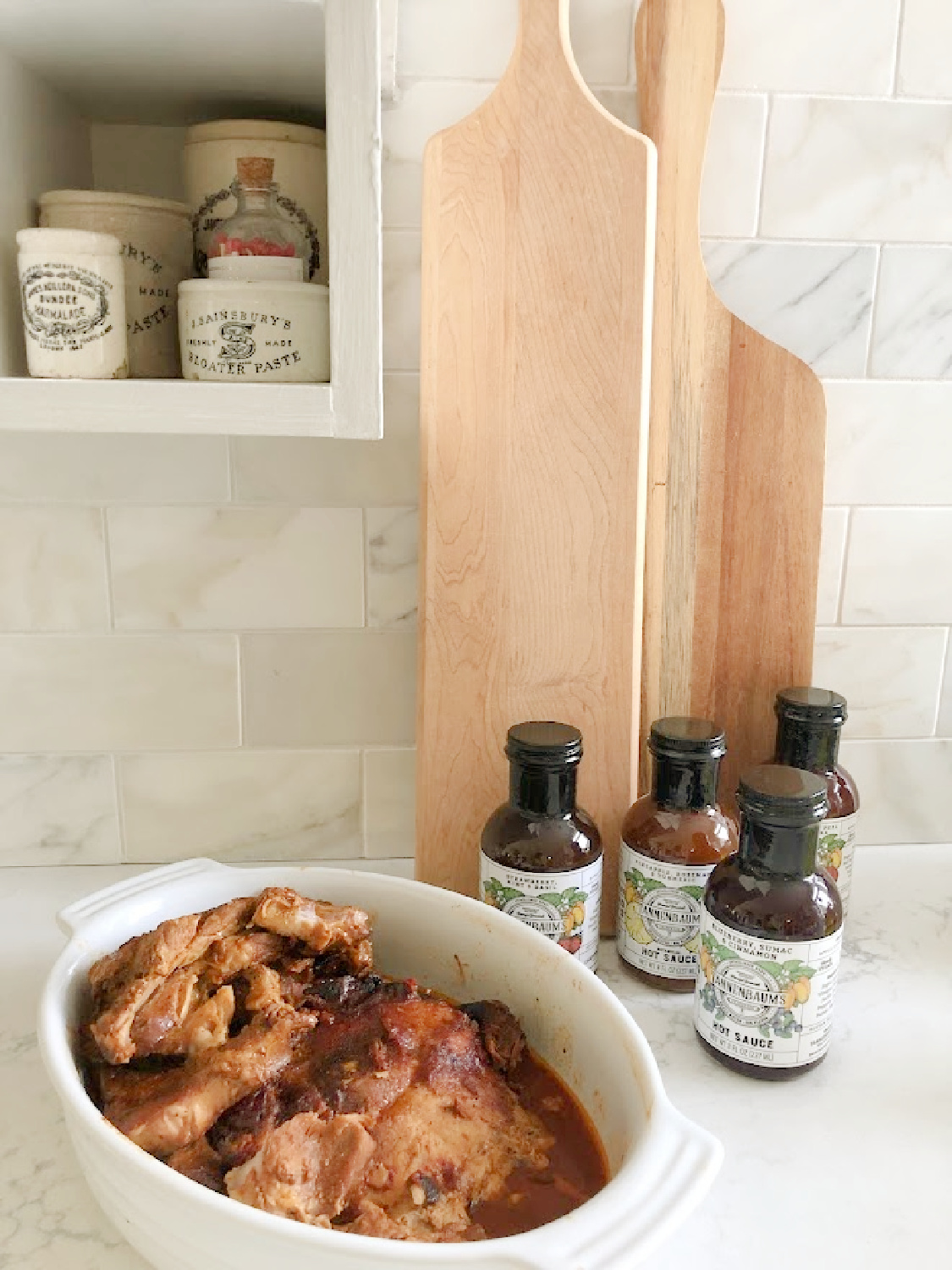 Tannenbaum's Hot Sauce with bbq pork on my kitchen counter - Hello Lovely Studio.