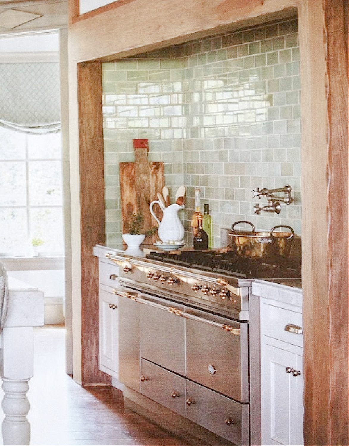 Soft green subway tiled backsplash and French range in a beautiful kitchen by Desiree Ashworth. #frenchkitchen #greentiledbacksplash