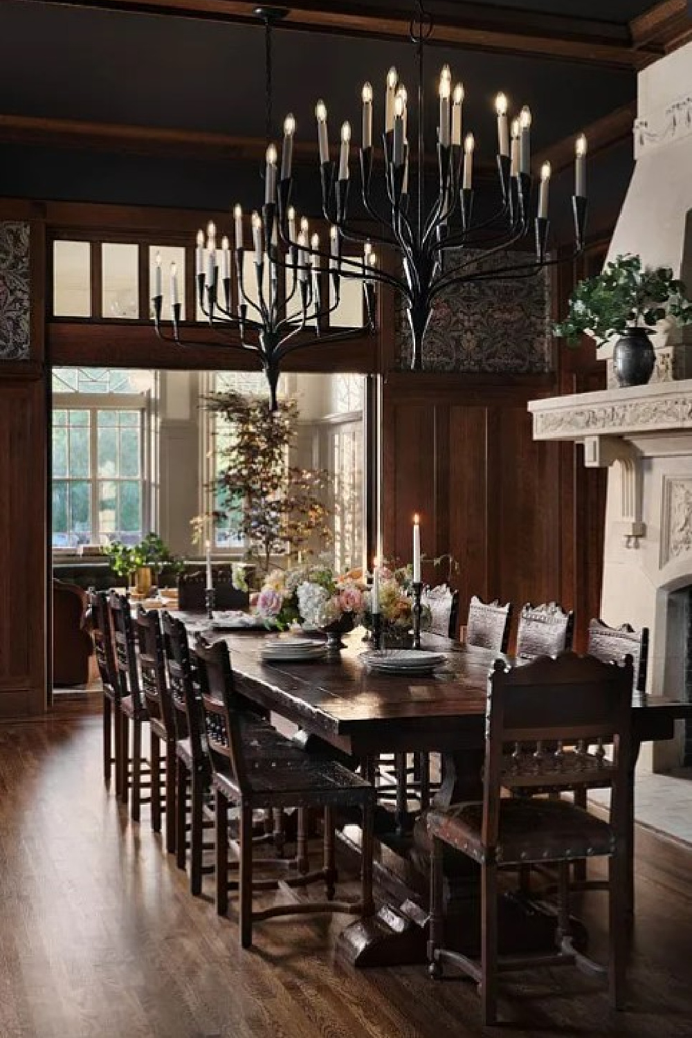 Dark wood paneled dining room with original French stone fireplace in Fixer Upper The Castle renovation.