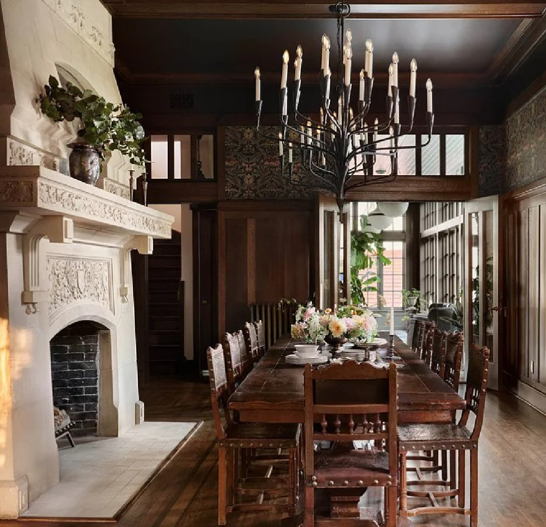 Dark wood paneled dining room with original French stone fireplace in Fixer Upper The Castle renovation.